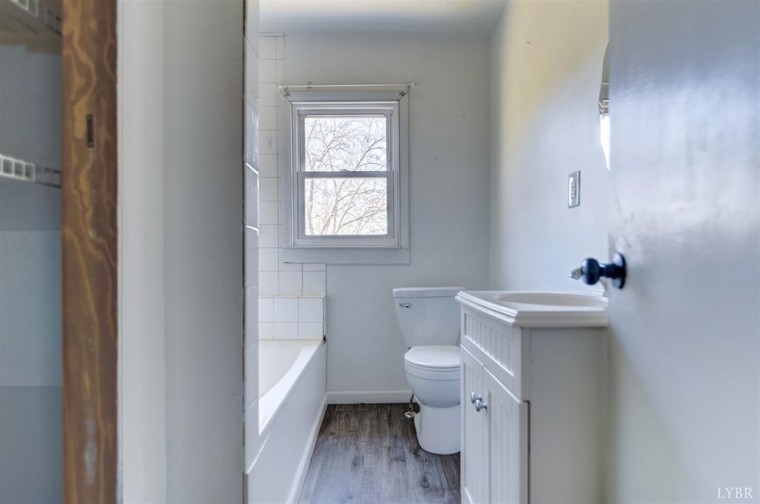 2730 New Chapel Road Rustburg, VA 24588 - Photo 6 of 31 a bathroom with a sink toilet and window
