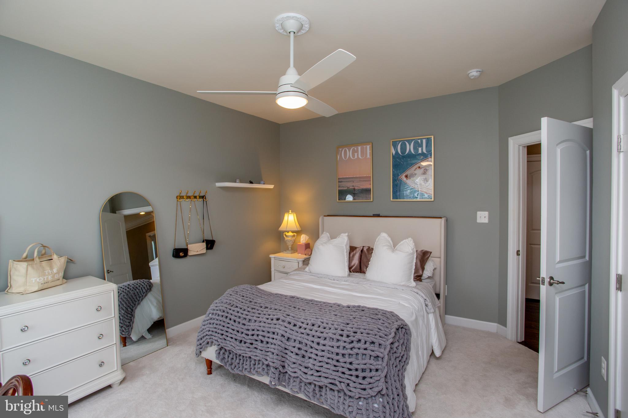 4682 Plough Tavern Road Doylestown, PA 18902 - Photo 24 of 42 a bedroom with a bed and a chandelier