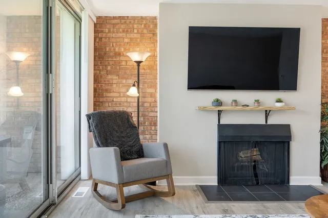a living room with furniture and a floor to ceiling window