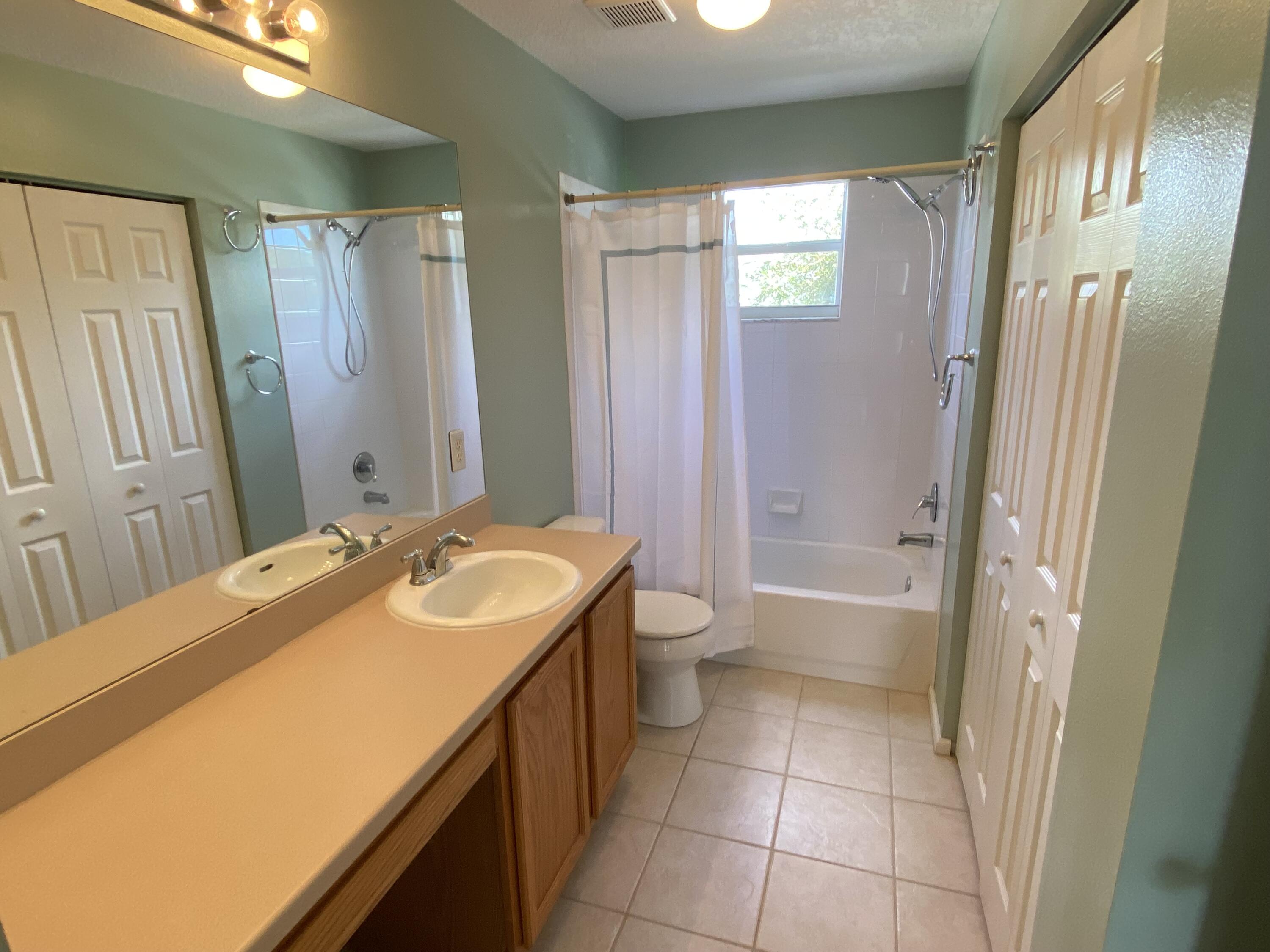 103 Pennock Landing Circle Jupiter, FL 33458 - Photo 15 of 18 a bathroom with a sink a toilet and shower