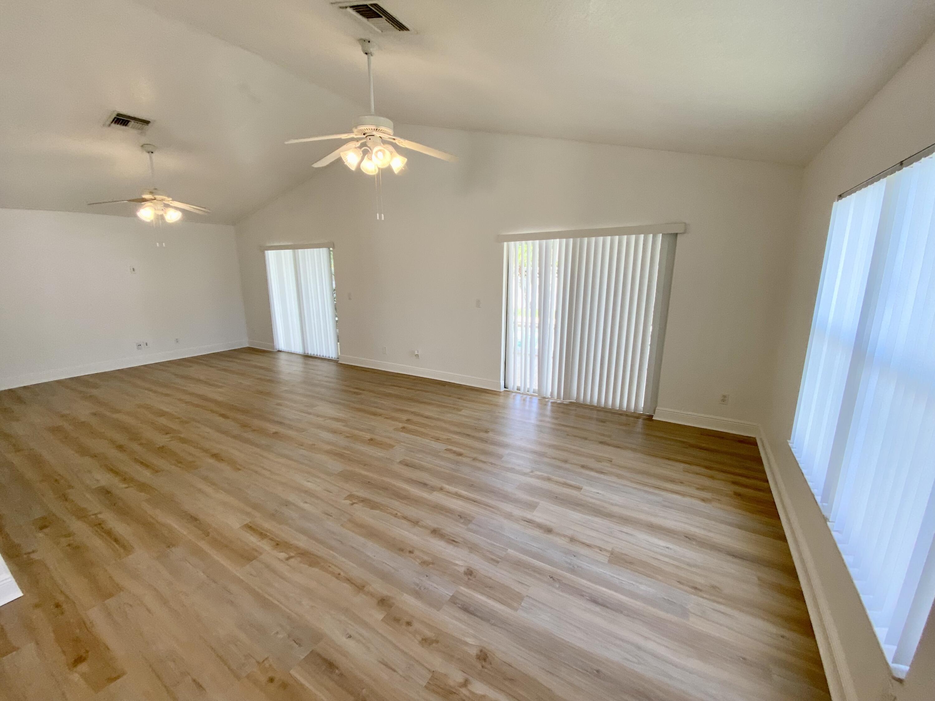 103 Pennock Landing Circle Jupiter, FL 33458 - Photo 3 of 18 a view of wooden floor and windows in a room
