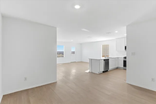 a view of a yard with wooden fence