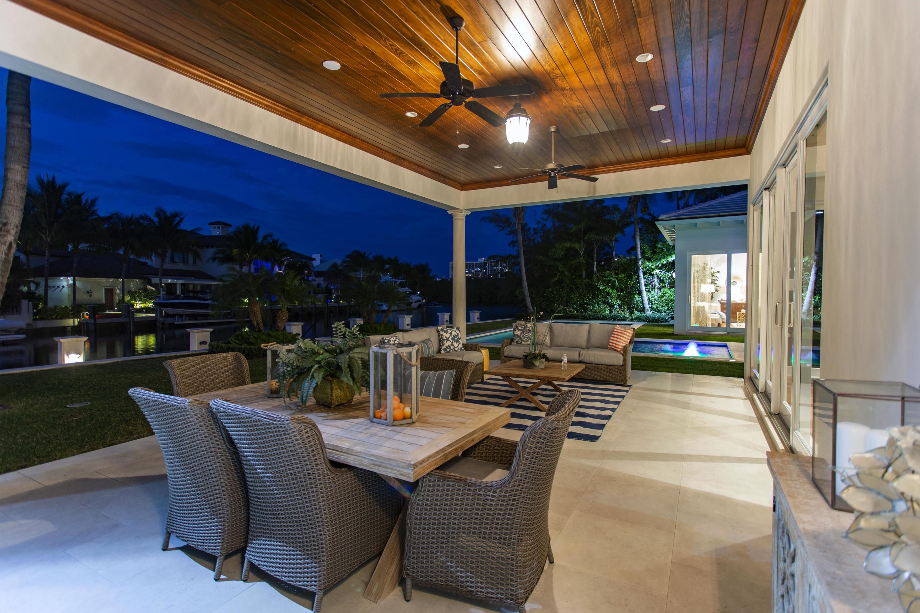 651 Northeast 45th Road Boca Raton, FL 33431 - Photo 20 of 23 a view of a patio with a dining table and chairs with a barbeque grill and a small yard