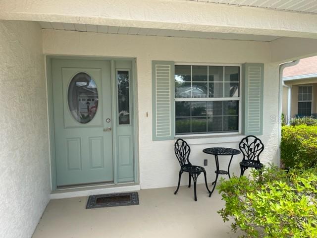 9782 Southwest 92nd Place Road Ocala, FL 34481 - Photo 1 of 1 a front view of a house with porch and furniture
