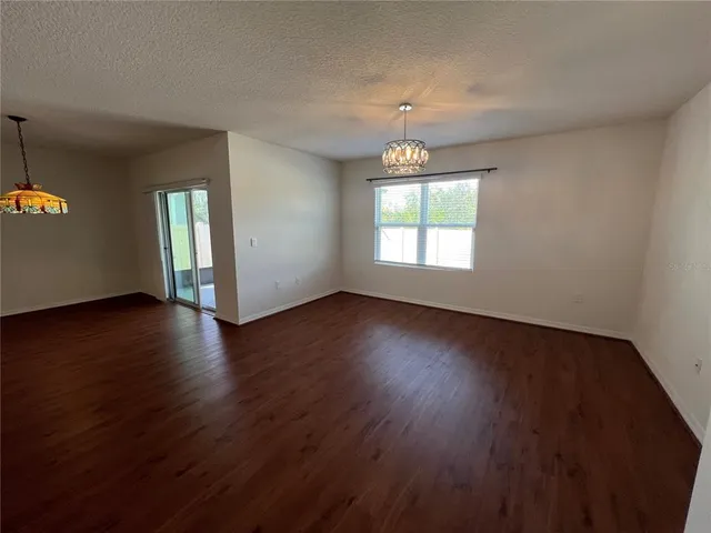 a kitchen with kitchen island granite countertop a refrigerator and a sink