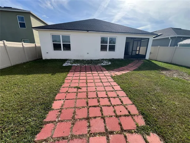 a backyard of a house with table and chairs