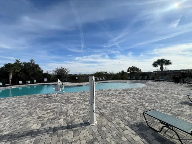 a front view of a house with a garden and trees