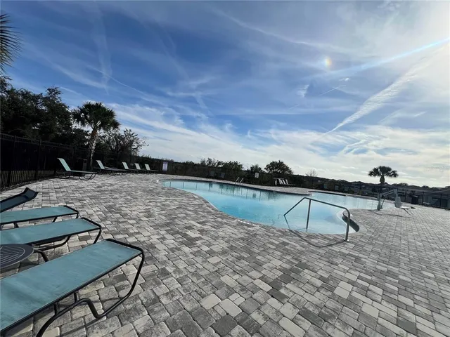 a view of a swimming pool with a patio
