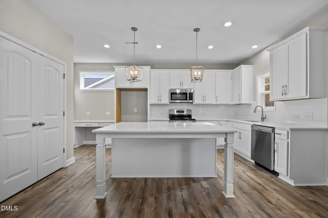 a kitchen with counter top space a sink cabinets and appliances