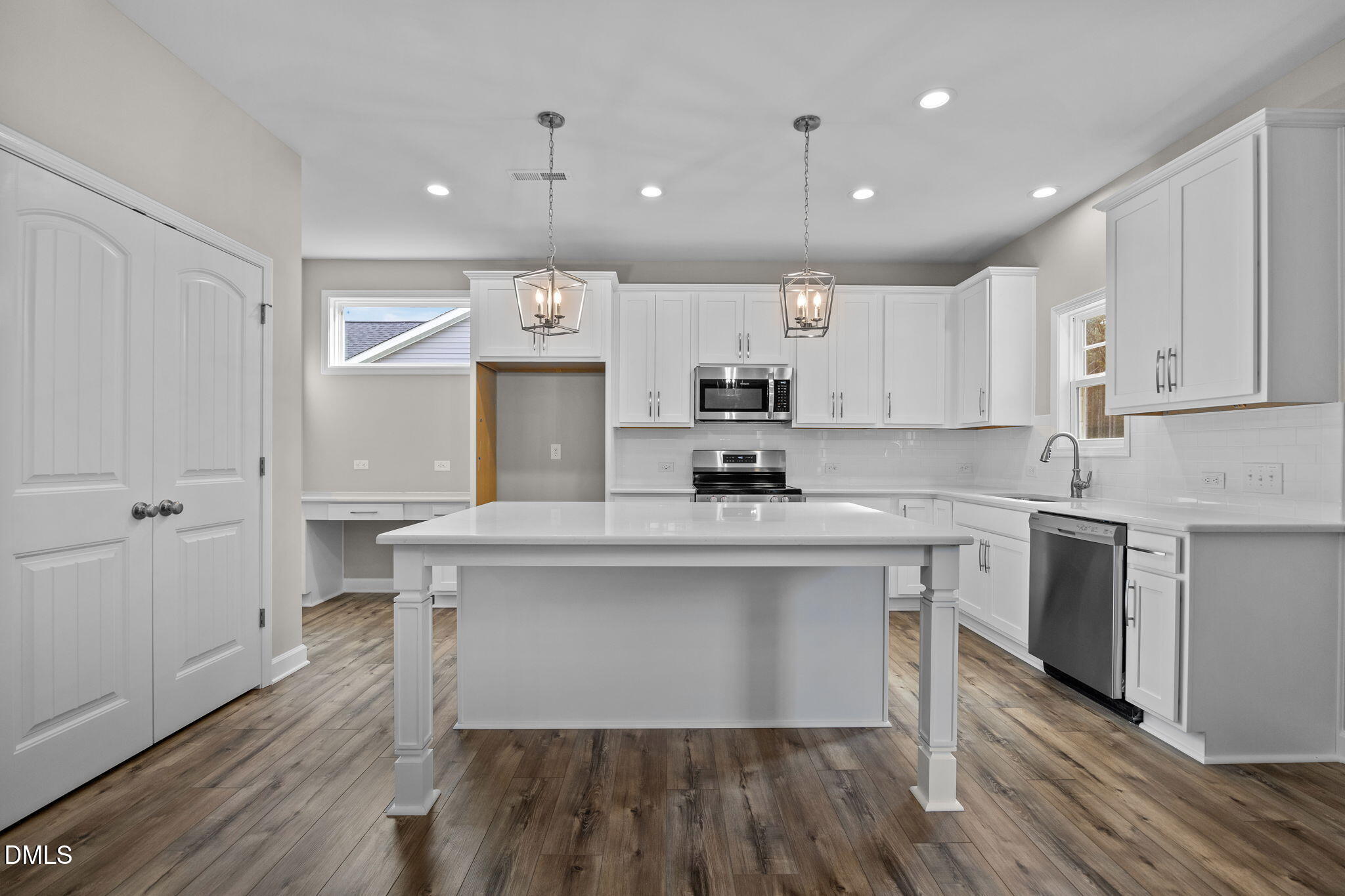74 Cardovia Way Wendell, NC 27591 - Photo 11 of 34 a kitchen with counter top space a sink cabinets and appliances