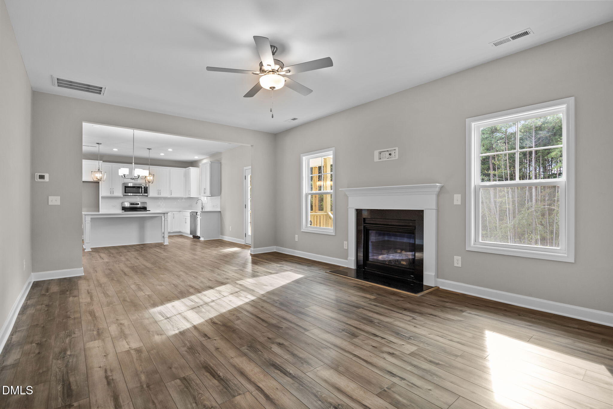 74 Cardovia Way Wendell, NC 27591 - Photo 13 of 34 a view of an empty room with wooden floor fireplace and a window