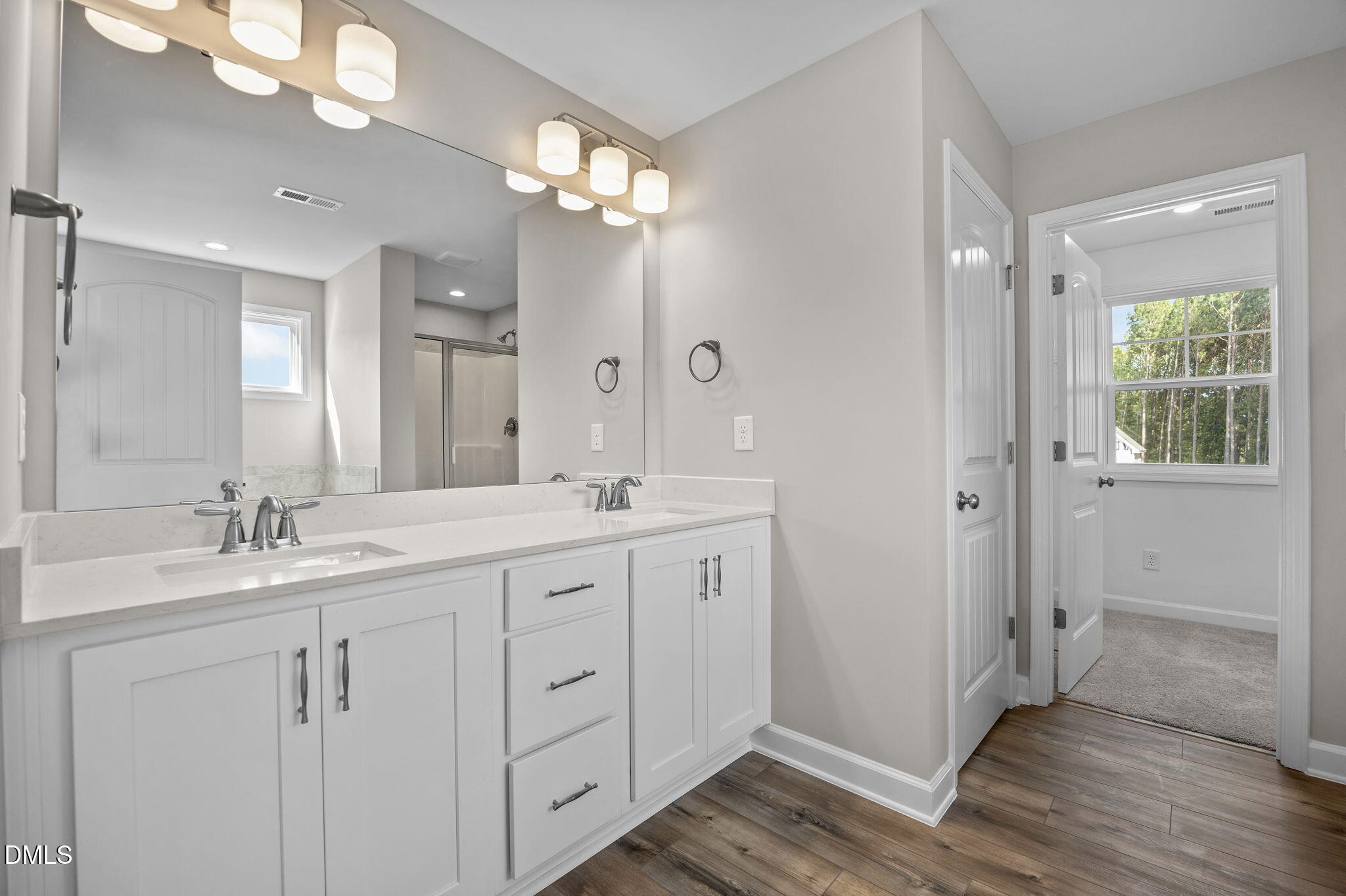 74 Cardovia Way Wendell, NC 27591 - Photo 25 of 34 a bathroom with a double vanity sink and mirror with shower