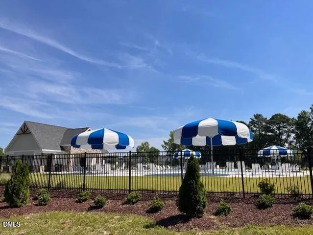 a view of a house with floor to ceiling windows and a table