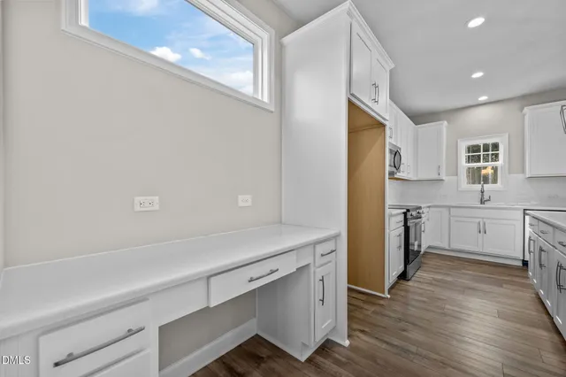 a kitchen with a refrigerator and a sink