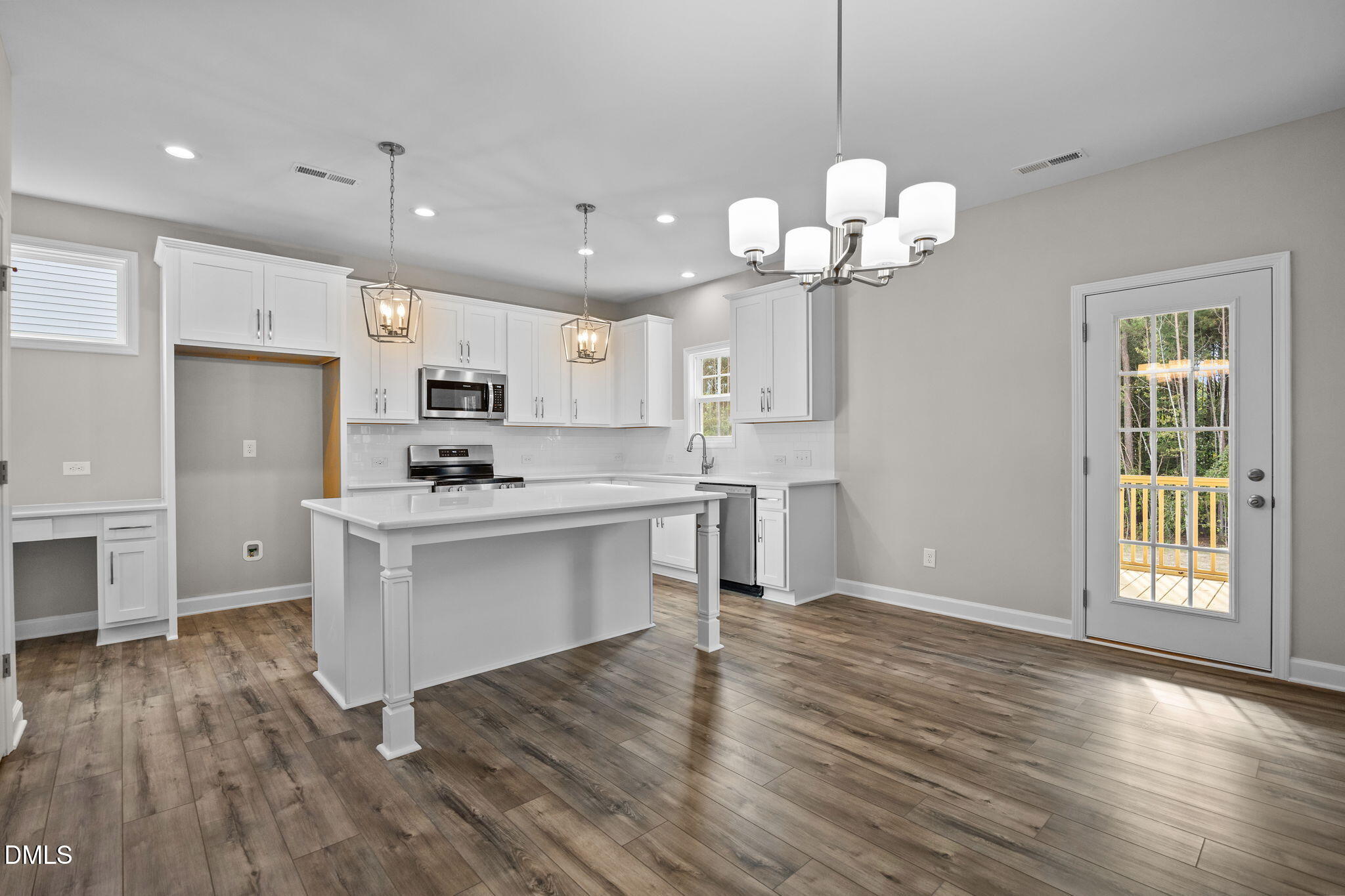 74 Cardovia Way Wendell, NC 27591 - Photo 10 of 34 a kitchen with stainless steel appliances granite countertop a refrigerator a sink dishwasher a stove and white cabinets with wooden floor