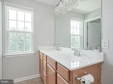 a bathroom with a sink and a window
