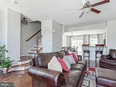 a living room with furniture white walls and potted plant