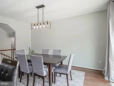 a view of a dining room with furniture wooden floor and a chandelier