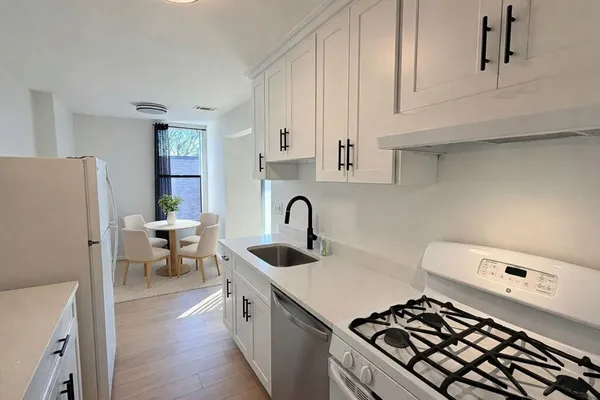 a kitchen with a sink and a stove top oven