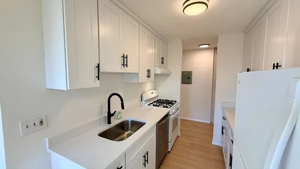 a kitchen with stainless steel appliances granite countertop a sink and a stove
