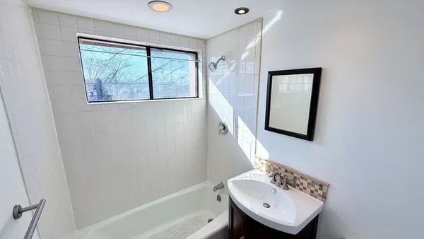 a bathroom with a sink a mirror and a bathtub