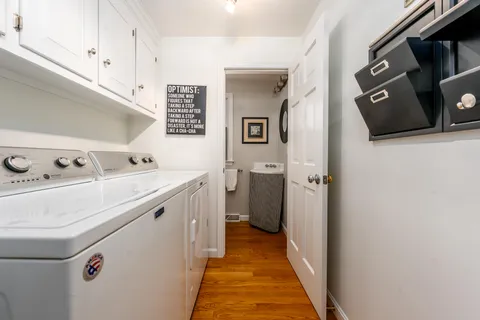 a bathroom with a granite countertop toilet sink and mirror