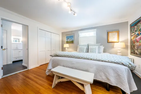 a living room with furniture a rug and a flat screen tv