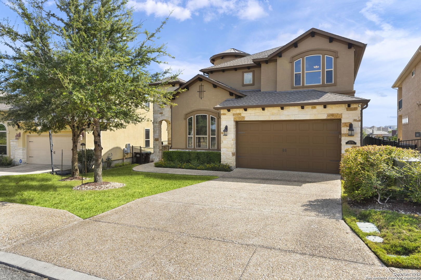 a front view of a house with a yard and garage