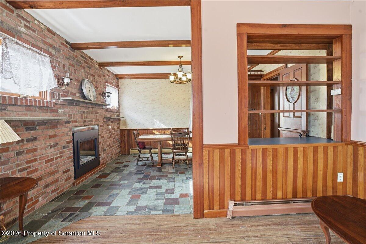 795 Wescott Road New Milford, PA 18834 - Photo 24 of 81 a living room with furniture a fireplace and a table