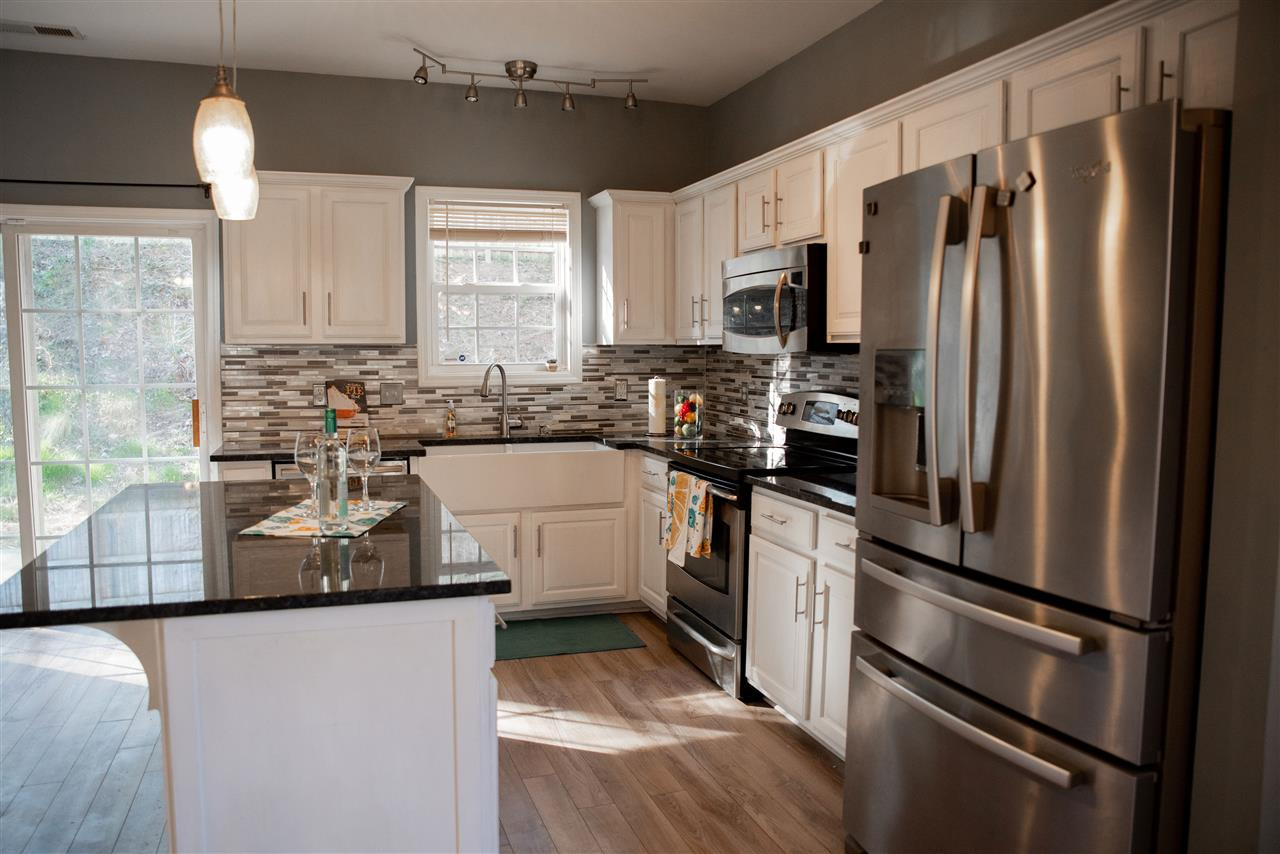 5848 Forest Point Road Raleigh, NC 27610 - Photo 5 of 21 Sellers added an island and farmhouse sink, updated appliances, cabinets, and countertops. Updated Kitchen