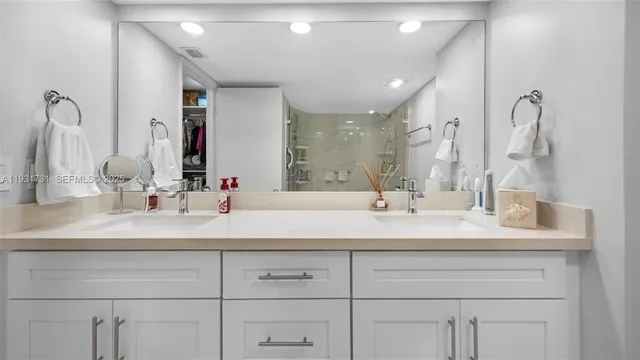 a bathroom with a sink double vanity and a mirror