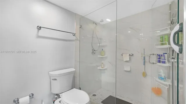 a bathroom with a shower a toilet and sink