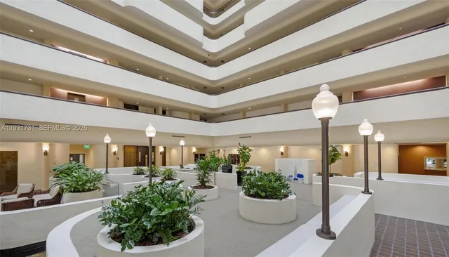 a lobby with furniture and potted plants