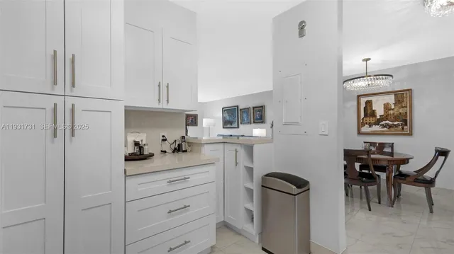 a kitchen with stainless steel appliances kitchen island granite countertop a table and chairs in it