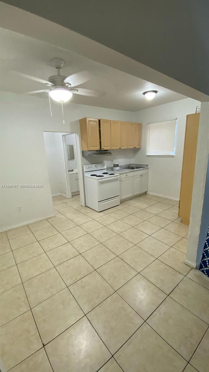 1021 Northwest 3rd Street, Unit 206 Miami, FL 33128 - Photo 2 of 13 a room with a washing machine and a refrigerator
