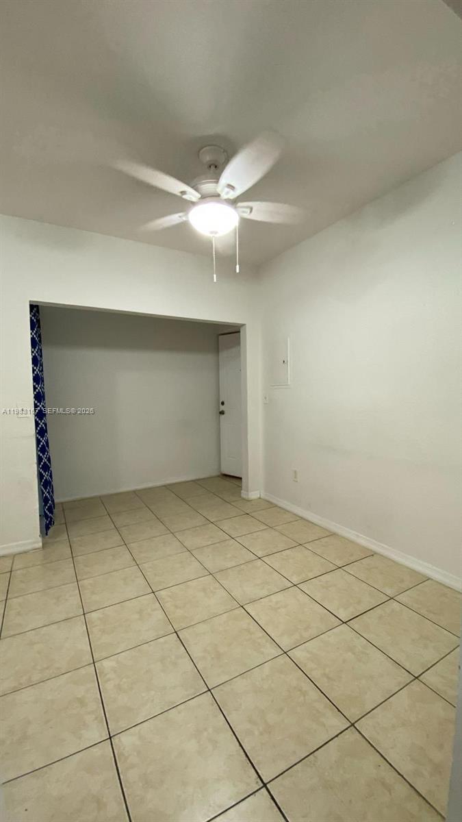 1021 Northwest 3rd Street, Unit 206 Miami, FL 33128 - Photo 4 of 13 a view of a room with an empty space and a ceiling fan