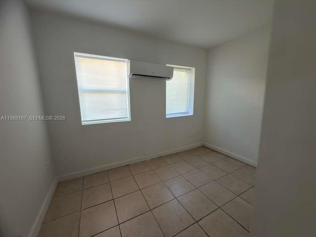 1021 Northwest 3rd Street, Unit 206 Miami, FL 33128 - Photo 9 of 13 an empty room with windows