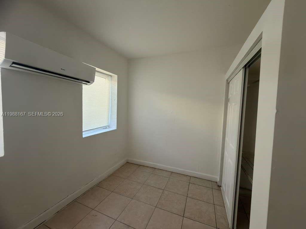 1021 Northwest 3rd Street, Unit 206 Miami, FL 33128 - Photo 10 of 13 a view of an empty room with a window