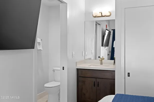 a bathroom with a sink a toilet and a mirror