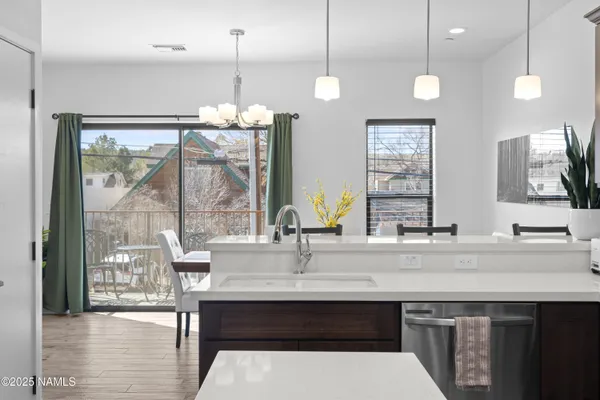 a kitchen with a sink a counter space appliances and cabinets