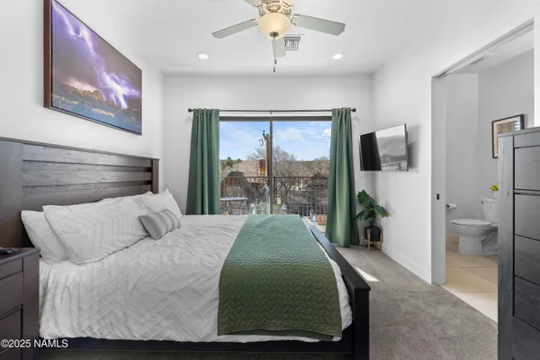 a living room with a bed furniture and a large window