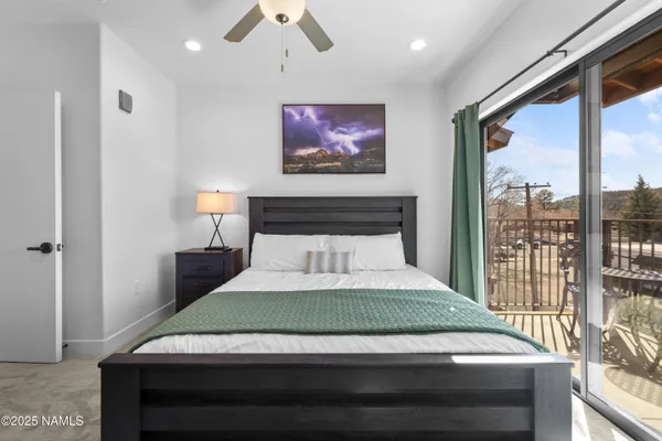 a bedroom with a large bed and a large window