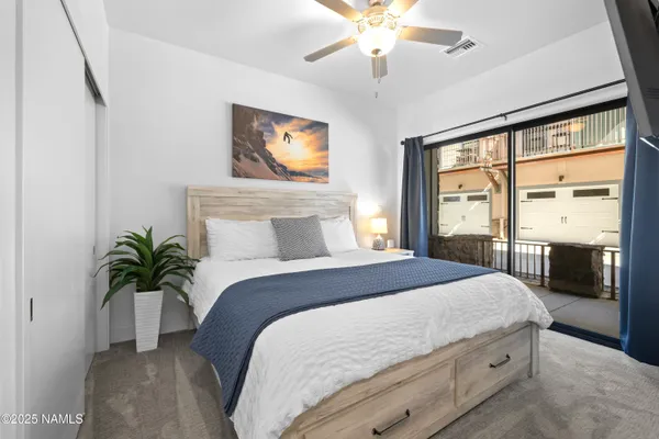 a bedroom with a large bed and a chandelier