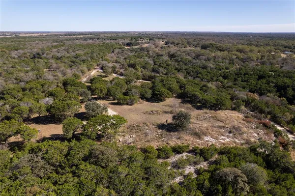 an aerial view of house with yard and mountain in the back