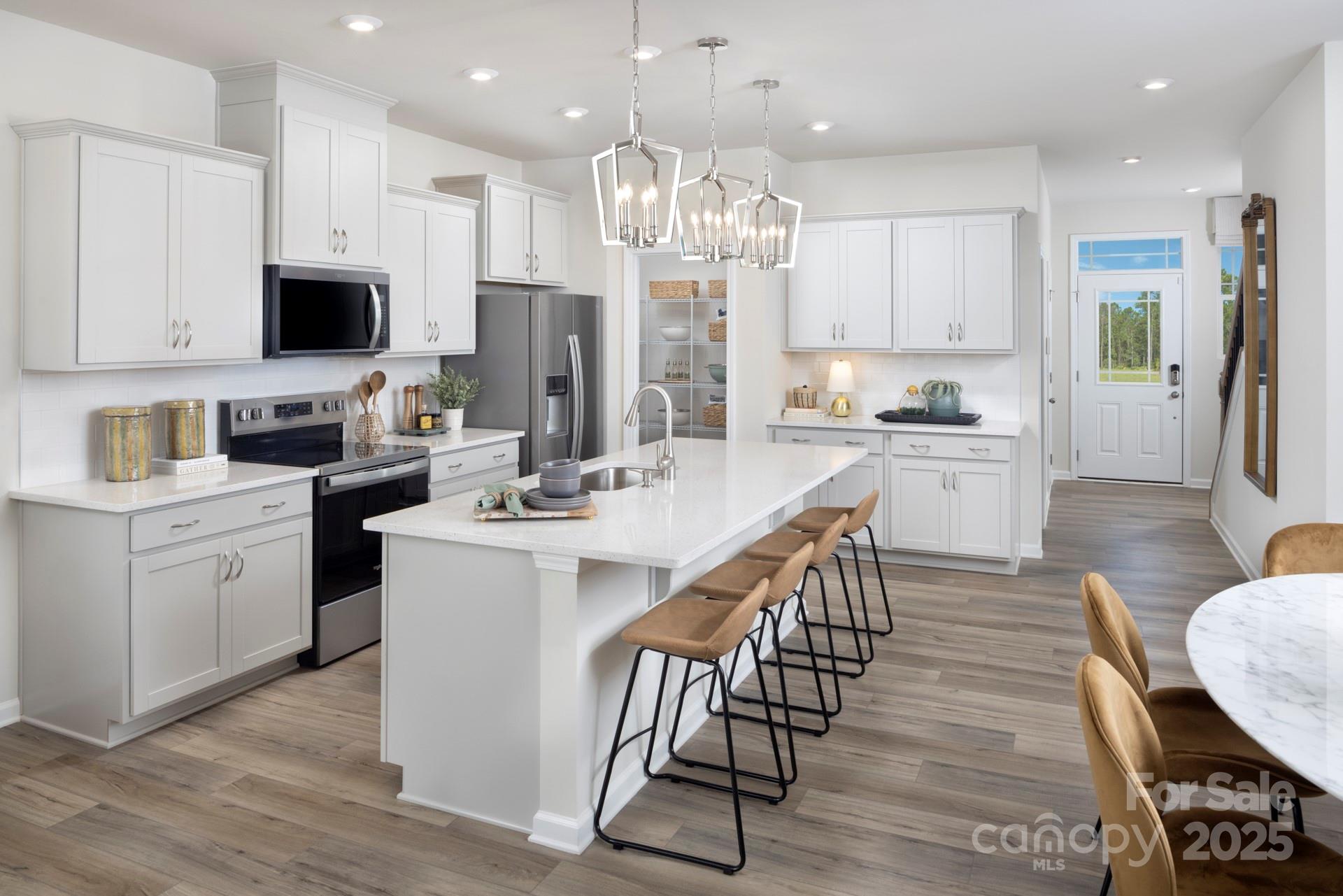 641 Cassidy Court Clover, SC 29710 - Photo 1 of 18 a kitchen with stainless steel appliances a dining table chairs stove refrigerator and cabinets
