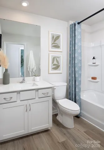 a bathroom with a sink toilet a mirror and shower