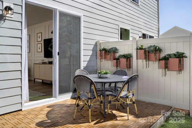 a view of a patio with table and chairs and potted plants