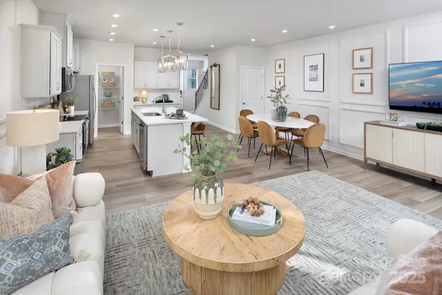 a living room with furniture and kitchen view