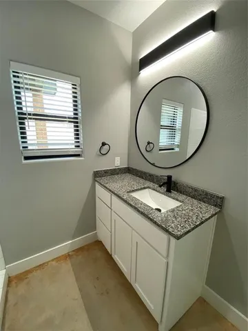a bathroom with a sink a toilet and mirror