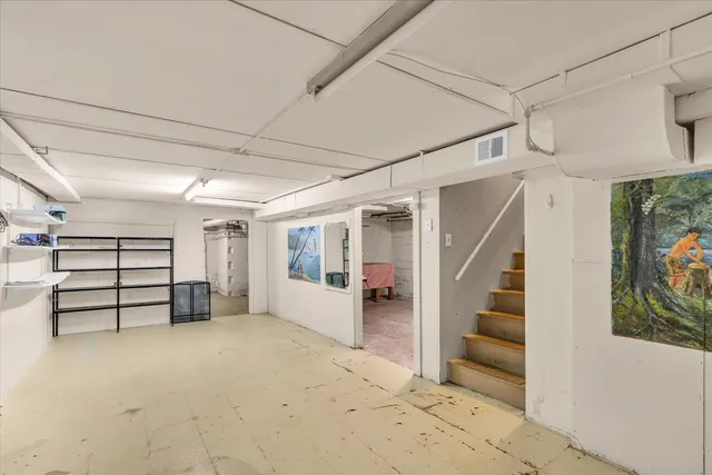 a view of empty room with stairs and furniture